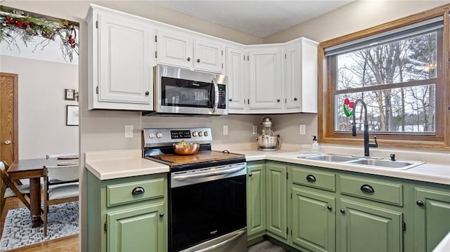 kitchen featuring white cabinetry, appliances with stainless steel finishes, and sink