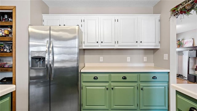 kitchen featuring white cabinets and stainless steel fridge with ice dispenser