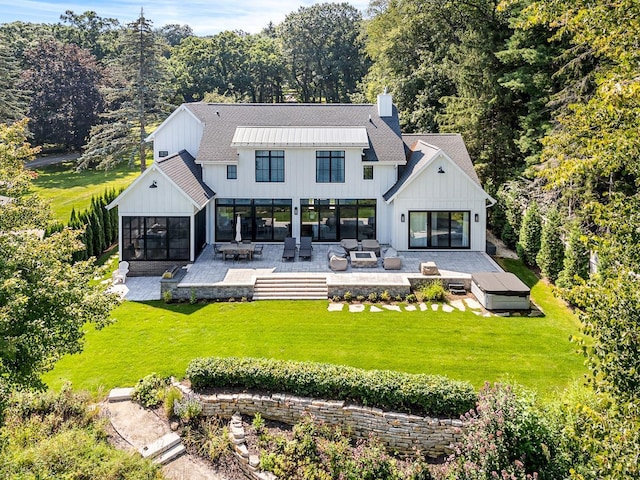 back of property featuring a sunroom, an outdoor hangout area, a yard, and a patio area