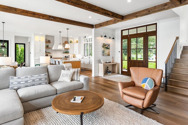 living room featuring plenty of natural light, dark hardwood / wood-style flooring, and beam ceiling