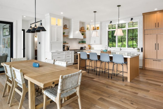 dining area featuring sink and light hardwood / wood-style floors