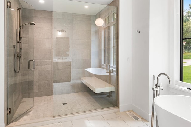 bathroom with tile patterned floors and separate shower and tub