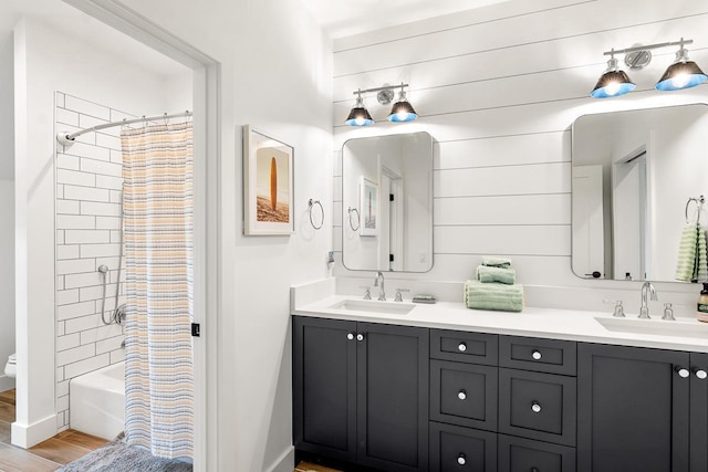 bathroom featuring vanity, hardwood / wood-style floors, and shower / bath combination with curtain