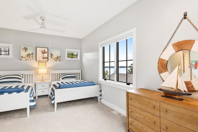 bedroom with ceiling fan and light colored carpet