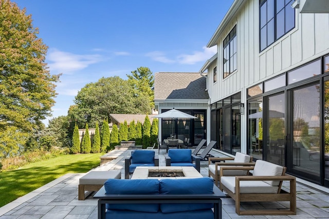 view of patio / terrace with an outdoor living space with a fire pit