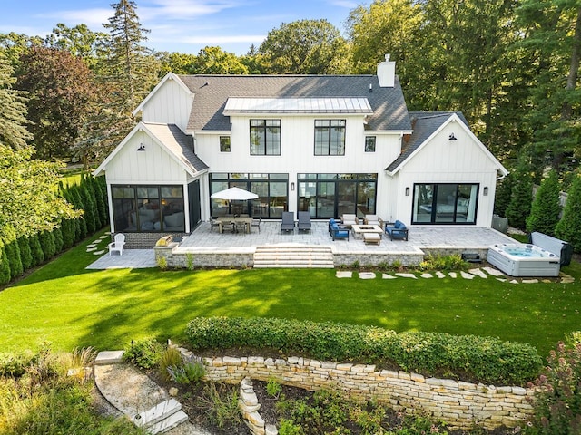 back of property featuring an outdoor living space, a yard, and a patio area