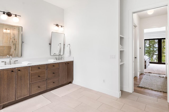 bathroom featuring vanity and built in shelves