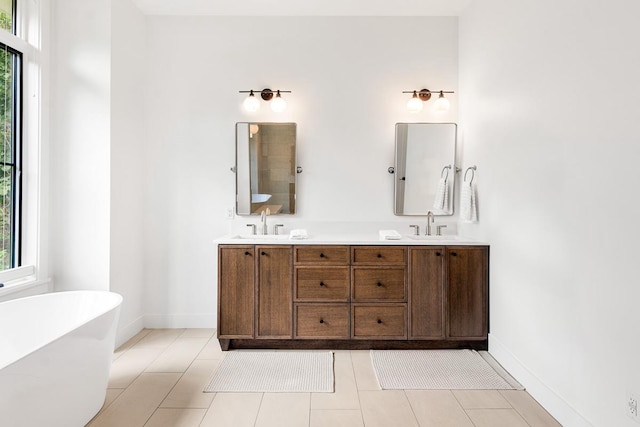 bathroom featuring vanity, tile patterned floors, and a bathing tub