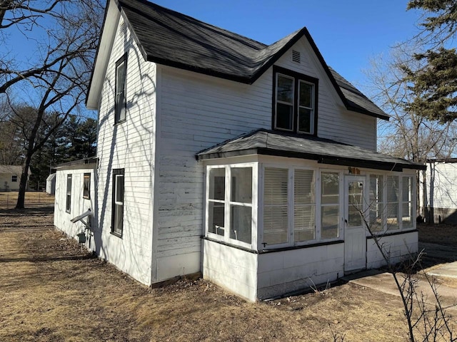 view of side of property featuring a sunroom