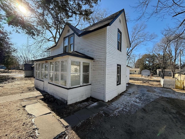 view of side of property featuring a sunroom