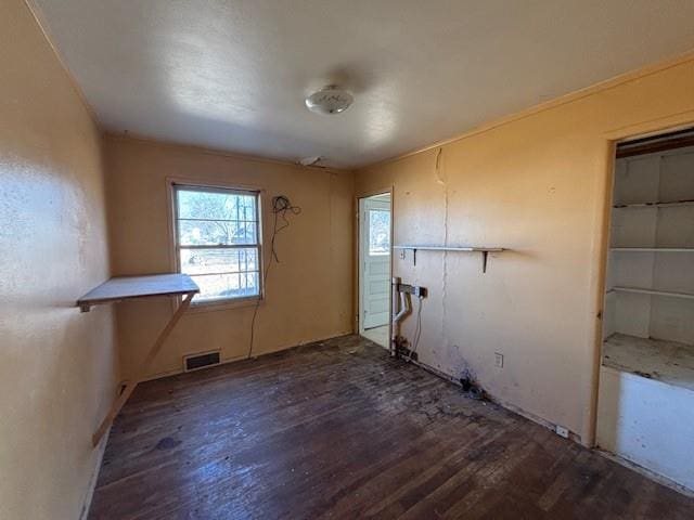 clothes washing area featuring visible vents and wood finished floors