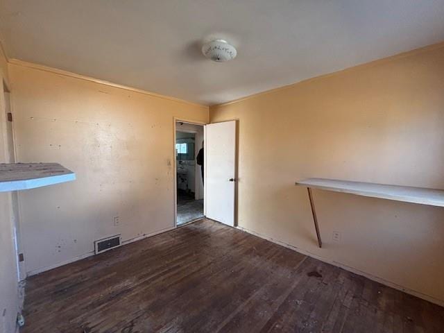 unfurnished room featuring visible vents and wood finished floors