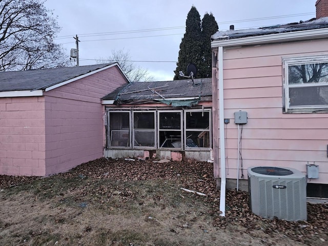 view of side of home with central air condition unit