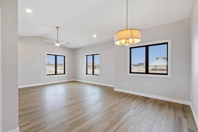 unfurnished room featuring wood-type flooring, lofted ceiling, and ceiling fan