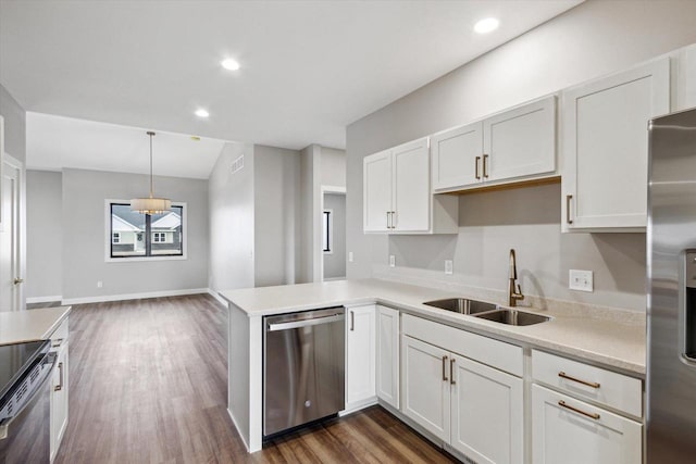 kitchen with sink, white cabinetry, decorative light fixtures, kitchen peninsula, and stainless steel appliances