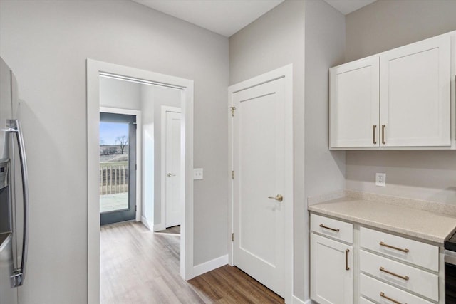 kitchen featuring white cabinets and light hardwood / wood-style floors