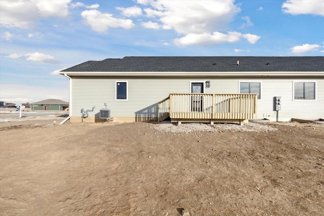 rear view of property with a wooden deck and central AC