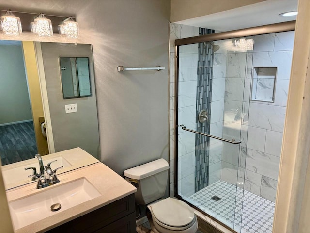 bathroom with vanity, toilet, and an enclosed shower