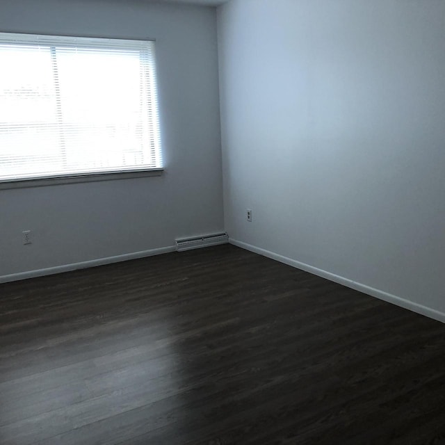 spare room with dark hardwood / wood-style flooring