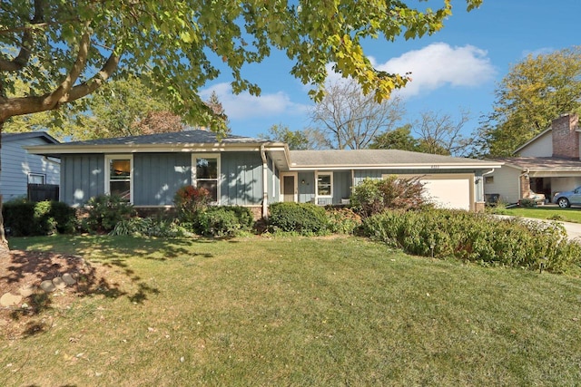 single story home with a garage and a front lawn