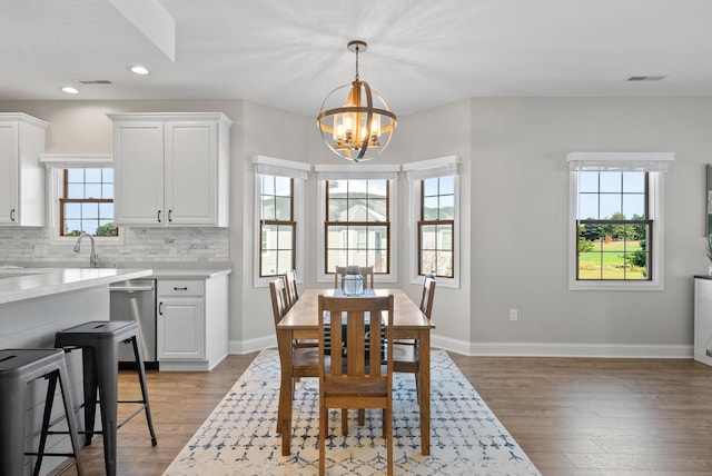 dining area with a chandelier and light hardwood / wood-style floors