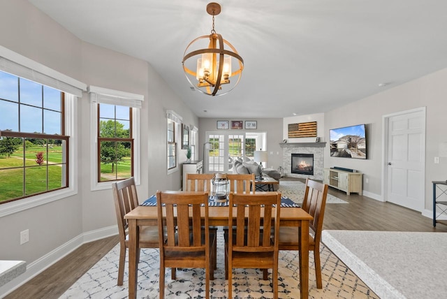 dining room featuring hardwood / wood-style flooring, plenty of natural light, and an inviting chandelier