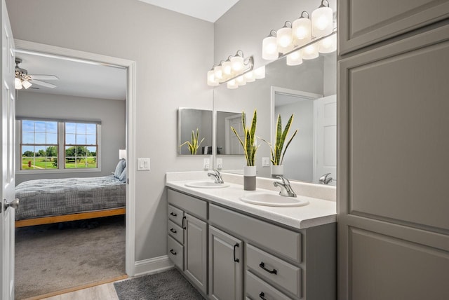 bathroom featuring vanity, hardwood / wood-style flooring, and ceiling fan