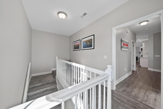 stairs featuring hardwood / wood-style floors