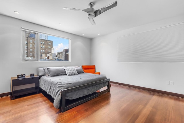 bedroom with hardwood / wood-style flooring and ceiling fan