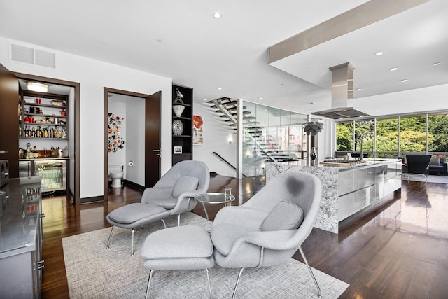 living room featuring bar, dark hardwood / wood-style floors, and beverage cooler