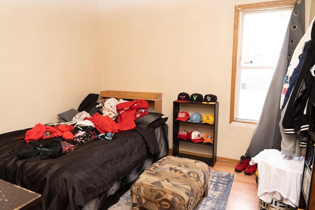 bedroom with hardwood / wood-style floors