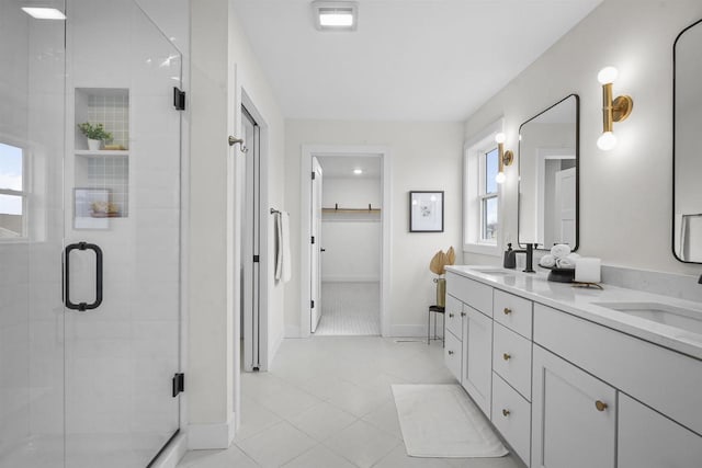 bathroom featuring tile patterned floors, vanity, and a shower with shower door