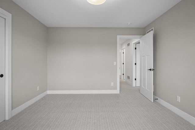 unfurnished room with light colored carpet