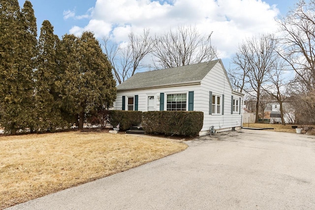 view of side of home with a yard