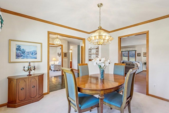 carpeted dining area with a notable chandelier and ornamental molding