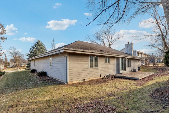 rear view of property featuring a lawn