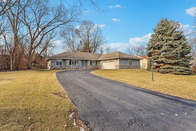 ranch-style home featuring a garage and a front lawn