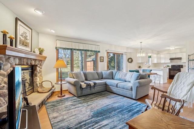 living room with a notable chandelier and light wood-type flooring