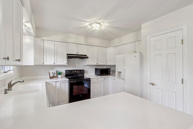 kitchen with sink, black appliances, and white cabinets