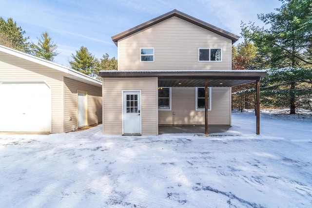 snow covered house featuring an outdoor structure