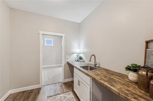 kitchen with sink, white cabinets, and dark hardwood / wood-style floors