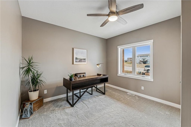 carpeted office featuring ceiling fan