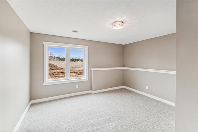 carpeted spare room featuring a textured ceiling