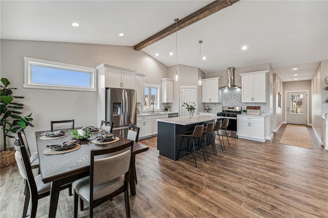 interior space featuring beamed ceiling, high vaulted ceiling, and dark wood-type flooring