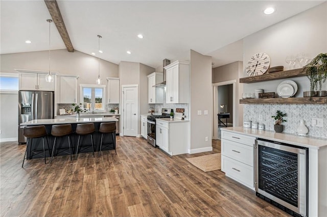 kitchen featuring wine cooler, decorative light fixtures, white cabinets, and appliances with stainless steel finishes