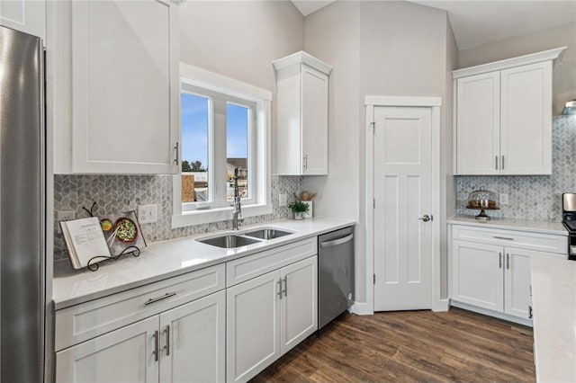 kitchen with stainless steel appliances, white cabinetry, sink, and dark hardwood / wood-style floors