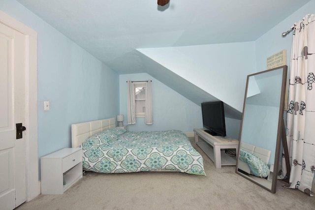 carpeted bedroom with vaulted ceiling