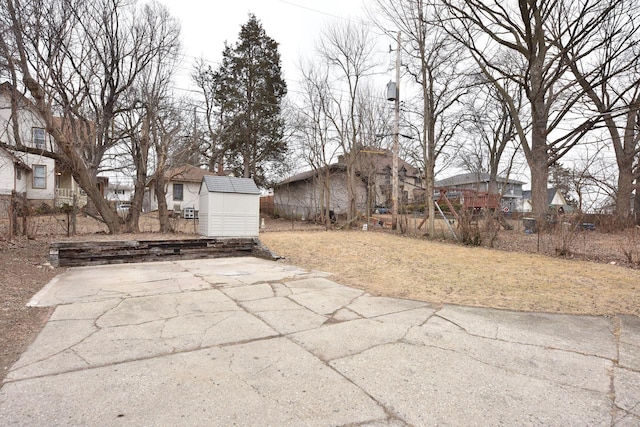 view of patio / terrace featuring a storage unit