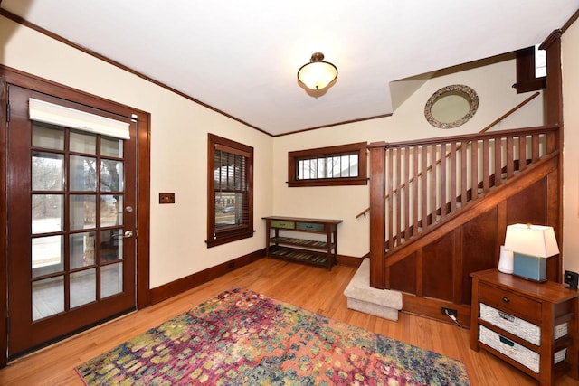 foyer entrance with hardwood / wood-style floors and crown molding