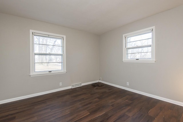 spare room featuring dark hardwood / wood-style floors